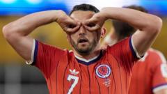 Why does Scotland's McGinn celebrate wiith goggles?