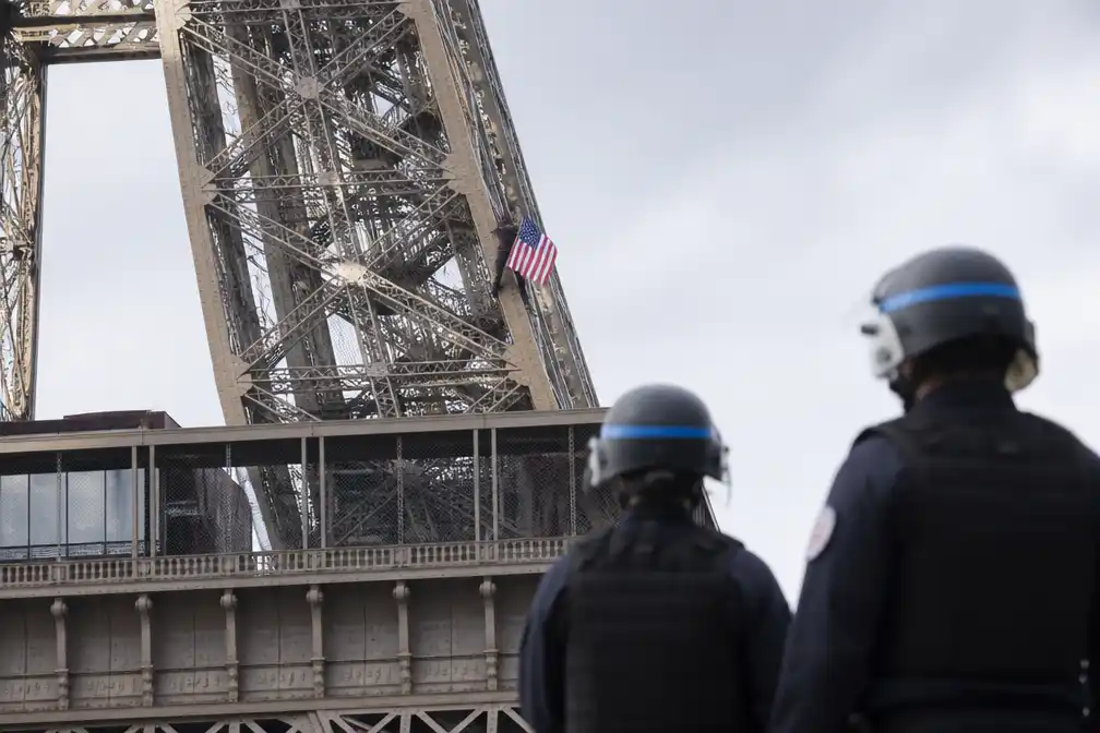 Man beklimt Eiffeltoren met Amerikaanse vlag, aangehouden in Parijs